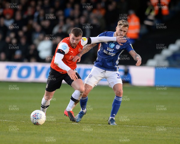 080220 - Luton Town v Cardiff City - Sky Bet Championship -  Luton's James Collins fends off a challenge from Cardiff's Joe Bennett