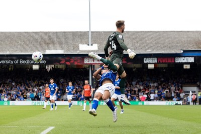 230825 - Luton Town v Cardiff City - Sky Bet League 1 - Luton Town’s Josh Keeley leaps into Cardiff Cty’s Callum Robinson