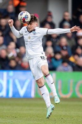 040323 - Luton Town v Swansea City - Sky Bet Championship - Luke Cundle of Swansea City heads the ball