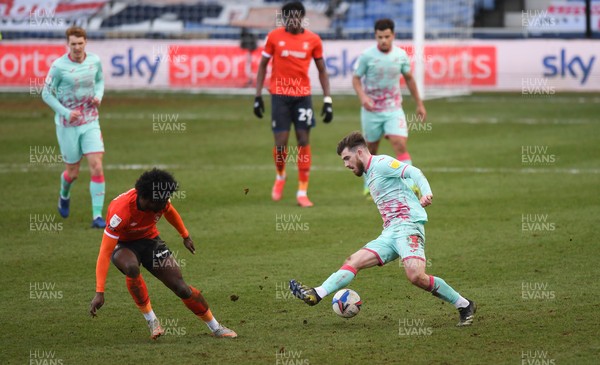 130321 - Luton Town v Swansea City - Sky Bet Championship - Ryan Manning of Swansea City holds off the challenge from Pelly Ruddock Mpanzu of Luton Town