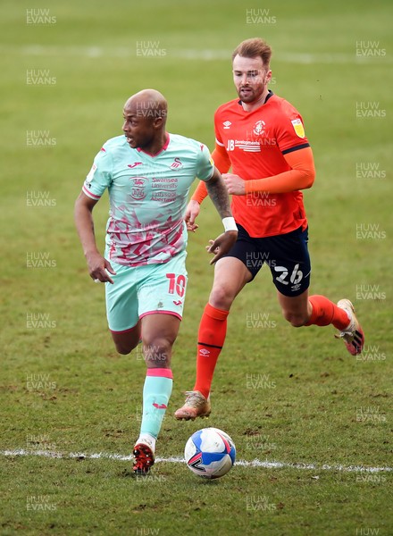 130321 - Luton Town v Swansea City - Sky Bet Championship - Andre Ayew of Swansea City  holds off the challenge from James Bree of Luton Town