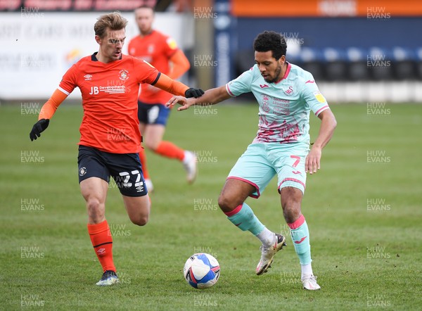 130321 - Luton Town v Swansea City - Sky Bet Championship - Korey Smith of Swansea City holds off the challenge from Kiernan Dewsbury-Hall of Luton Town