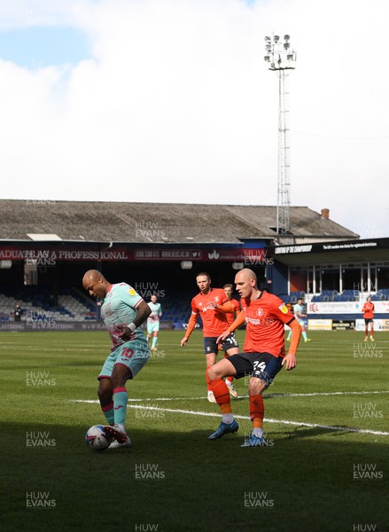 130321 - Luton Town v Swansea City - Sky Bet Championship - Andre Ayew of Swansea City holds off the challenge from Kal Naismith of Luton Town