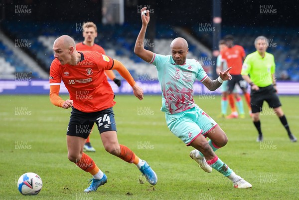 130321 - Luton Town v Swansea City - Sky Bet Championship - Kal Naismith of Luton Town holds off the challenge from Andre Ayew of Swansea City 