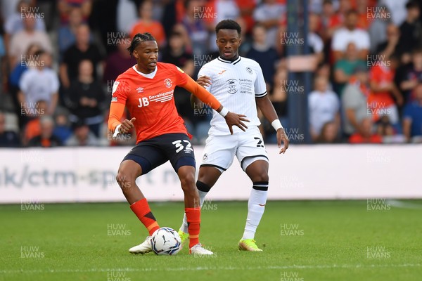 180921 - Luton Town v Swansea City - Sky Bet Championship - Gabriel Osho of Luton Town holds off the challenge from Ethan Laird of Swansea City 
