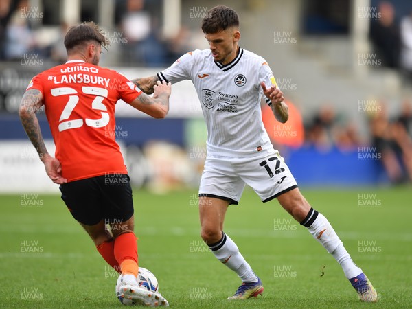 180921 - Luton Town v Swansea City - Sky Bet Championship - Jamie Paterson of Swansea City  battles for possession with Henri Lansbury of Luton Town