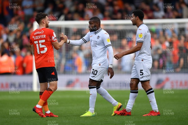 180921 - Luton Town v Swansea City - Sky Bet Championship - Olivier Ntcham of Swansea City with Tom Lockyer of Luton Town at the final whistle