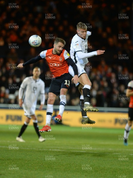 211219 - Luton Town v Swansea City - Sky Bet Championship -  Swansea's Matt Grimes challenges Luton's Andrew Shinnie to the ball