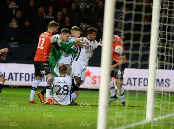 211219 - Luton Town v Swansea City - Sky Bet Championship -  Swansea's Wayne Routledge clashes with Luton's Matty Pearson after a challenge