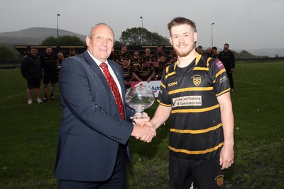 020526 - Maesteg RFC - Admiral National League 4 West Central Trophy Presentation - WRU representative Kerry Frey presents trophy to Maesteg RFC captain Jordan Richards as Maesteg RFC players celebrate winning their league 