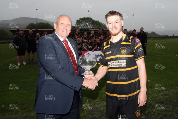 020526 - Maesteg RFC - Admiral National League 4 West Central Trophy Presentation - WRU representative Kerry Frey presents trophy to Maesteg RFC captain Jordan Richards as Maesteg RFC players celebrate winning their league 