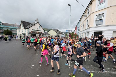 110622 - Whole Earth Man v Horse Race - Competitors take part in the Whole Earth Man v Horse race in Llanwrtyd Wells, Wales Running for over 40 years, Man v Horse is an epic 225-mile challenge which pits humans against horses across a multi-terrain course It is being staged for the first time after a two year absence due to the Covid Pandemic Picture shows runners at the start 