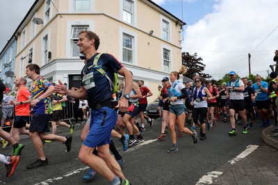 110622 - Whole Earth Man v Horse Race - Competitors take part in the Whole Earth Man v Horse race in Llanwrtyd Wells, Wales Running for over 40 years, Man v Horse is an epic 225-mile challenge which pits humans against horses across a multi-terrain course It is being staged for the first time after a two year absence due to the Covid Pandemic Picture shows runners at the start 