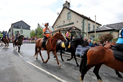 110622 - Whole Earth Man v Horse Race - Competitors take part in the Whole Earth Man v Horse race in Llanwrtyd Wells, Wales Running for over 40 years, Man v Horse is an epic 225-mile challenge which pits humans against horses across a multi-terrain course It is being staged for the first time after a two year absence due to the Covid Pandemic Picture shows horses and riders at the start 