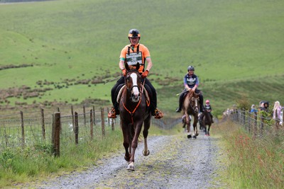 110622 - Whole Earth Man v Horse Race - Competitors take part in the Whole Earth Man v Horse race in Llanwrtyd Wells, Wales Running for over 40 years, Man v Horse is an epic 225-mile challenge which pits humans against horses across a multi-terrain course It is being staged for the first time after a two year absence due to the Covid Pandemic