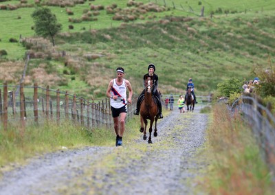 110622 - Whole Earth Man v Horse Race - Competitors take part in the Whole Earth Man v Horse race in Llanwrtyd Wells, Wales Running for over 40 years, Man v Horse is an epic 225-mile challenge which pits humans against horses across a multi-terrain course It is being staged for the first time after a two year absence due to the Covid Pandemic