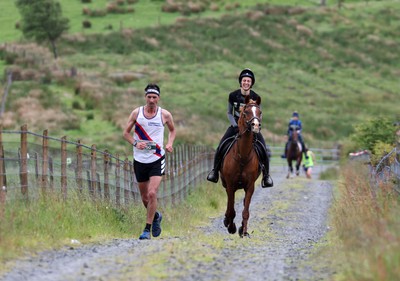 110622 - Whole Earth Man v Horse Race - Competitors take part in the Whole Earth Man v Horse race in Llanwrtyd Wells, Wales Running for over 40 years, Man v Horse is an epic 225-mile challenge which pits humans against horses across a multi-terrain course It is being staged for the first time after a two year absence due to the Covid Pandemic