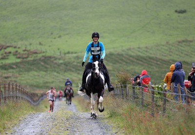 110622 - Whole Earth Man v Horse Race - Competitors take part in the Whole Earth Man v Horse race in Llanwrtyd Wells, Wales Running for over 40 years, Man v Horse is an epic 225-mile challenge which pits humans against horses across a multi-terrain course It is being staged for the first time after a two year absence due to the Covid Pandemic