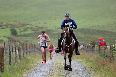 110622 - Whole Earth Man v Horse Race - Competitors take part in the Whole Earth Man v Horse race in Llanwrtyd Wells, Wales Running for over 40 years, Man v Horse is an epic 225-mile challenge which pits humans against horses across a multi-terrain course It is being staged for the first time after a two year absence due to the Covid Pandemic