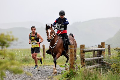 110622 - Whole Earth Man v Horse Race - Competitors take part in the Whole Earth Man v Horse race in Llanwrtyd Wells, Wales Running for over 40 years, Man v Horse is an epic 225-mile challenge which pits humans against horses across a multi-terrain course It is being staged for the first time after a two year absence due to the Covid Pandemic