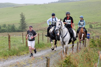 110622 - Whole Earth Man v Horse Race - Competitors take part in the Whole Earth Man v Horse race in Llanwrtyd Wells, Wales Running for over 40 years, Man v Horse is an epic 225-mile challenge which pits humans against horses across a multi-terrain course It is being staged for the first time after a two year absence due to the Covid Pandemic