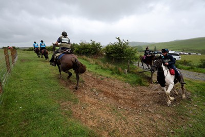 110622 - Whole Earth Man v Horse Race - Competitors take part in the Whole Earth Man v Horse race in Llanwrtyd Wells, Wales Running for over 40 years, Man v Horse is an epic 225-mile challenge which pits humans against horses across a multi-terrain course It is being staged for the first time after a two year absence due to the Covid Pandemic