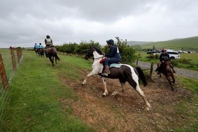 110622 - Whole Earth Man v Horse Race - Competitors take part in the Whole Earth Man v Horse race in Llanwrtyd Wells, Wales Running for over 40 years, Man v Horse is an epic 225-mile challenge which pits humans against horses across a multi-terrain course It is being staged for the first time after a two year absence due to the Covid Pandemic