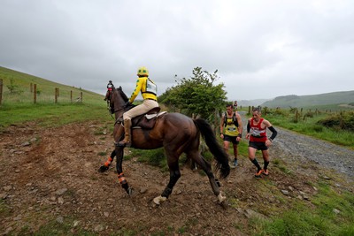 110622 - Whole Earth Man v Horse Race - Competitors take part in the Whole Earth Man v Horse race in Llanwrtyd Wells, Wales Running for over 40 years, Man v Horse is an epic 225-mile challenge which pits humans against horses across a multi-terrain course It is being staged for the first time after a two year absence due to the Covid Pandemic