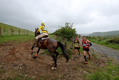 110622 - Whole Earth Man v Horse Race - Competitors take part in the Whole Earth Man v Horse race in Llanwrtyd Wells, Wales Running for over 40 years, Man v Horse is an epic 225-mile challenge which pits humans against horses across a multi-terrain course It is being staged for the first time after a two year absence due to the Covid Pandemic