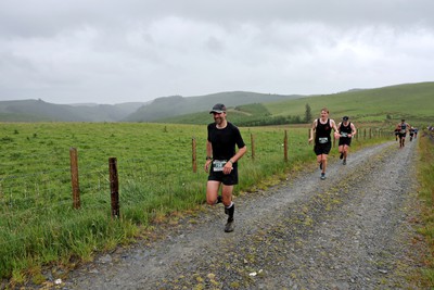 110622 - Whole Earth Man v Horse Race - Competitors take part in the Whole Earth Man v Horse race in Llanwrtyd Wells, Wales Running for over 40 years, Man v Horse is an epic 225-mile challenge which pits humans against horses across a multi-terrain course It is being staged for the first time after a two year absence due to the Covid Pandemic