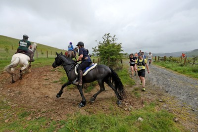 110622 - Whole Earth Man v Horse Race - Competitors take part in the Whole Earth Man v Horse race in Llanwrtyd Wells, Wales Running for over 40 years, Man v Horse is an epic 225-mile challenge which pits humans against horses across a multi-terrain course It is being staged for the first time after a two year absence due to the Covid Pandemic