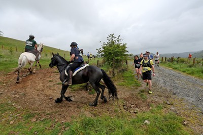 110622 - Whole Earth Man v Horse Race - Competitors take part in the Whole Earth Man v Horse race in Llanwrtyd Wells, Wales Running for over 40 years, Man v Horse is an epic 225-mile challenge which pits humans against horses across a multi-terrain course It is being staged for the first time after a two year absence due to the Covid Pandemic