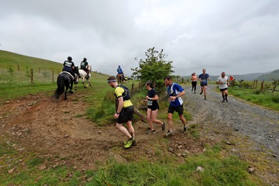 110622 - Whole Earth Man v Horse Race - Competitors take part in the Whole Earth Man v Horse race in Llanwrtyd Wells, Wales Running for over 40 years, Man v Horse is an epic 225-mile challenge which pits humans against horses across a multi-terrain course It is being staged for the first time after a two year absence due to the Covid Pandemic