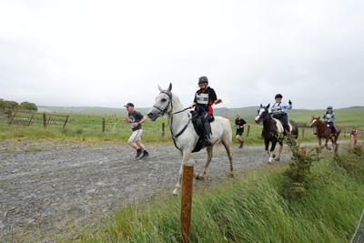 110622 - Whole Earth Man v Horse Race - Competitors take part in the Whole Earth Man v Horse race in Llanwrtyd Wells, Wales Running for over 40 years, Man v Horse is an epic 225-mile challenge which pits humans against horses across a multi-terrain course It is being staged for the first time after a two year absence due to the Covid Pandemic