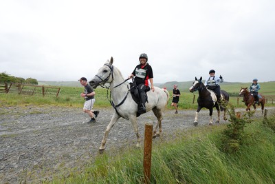 110622 - Whole Earth Man v Horse Race - Competitors take part in the Whole Earth Man v Horse race in Llanwrtyd Wells, Wales Running for over 40 years, Man v Horse is an epic 225-mile challenge which pits humans against horses across a multi-terrain course It is being staged for the first time after a two year absence due to the Covid Pandemic