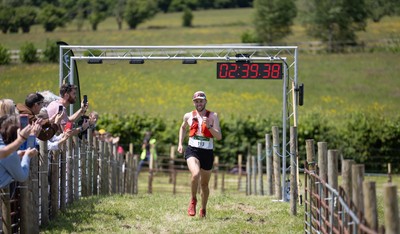 130626 - Man v Horse, Llanwrytd Wells - First runner across the finish line Daniel Connolly from Keswick comes home in the annual Man v Horse Race held at Llanwrytd Well, Powys, Wales He was eventually beaten by rider Rachel Lima from Pontypridd on her horse Zamell