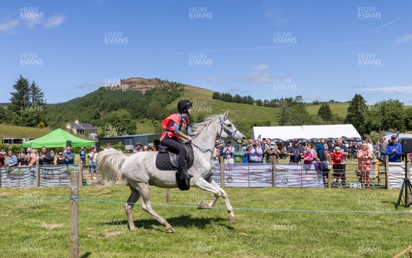 130626 - Man v Horse, Llanwrytd Wells - First horse across the finish line, and eventual winner, Zamell riden by Rachel Lima from Pontypridd comes home to win the annual Man v Horse Race held at Llanwrytd Well, Powys, Wales