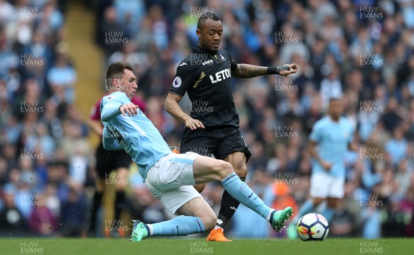 220418 - Manchester City v Swansea - Premier League - Jordan Ayew of Swansea is tackled by Aymeric Laporte of Manchester City