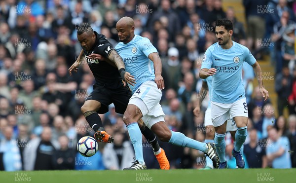 220418 - Manchester City v Swansea - Premier League - Jordan Ayew of Swansea is tackled by Vincent Kompany of Manchester City