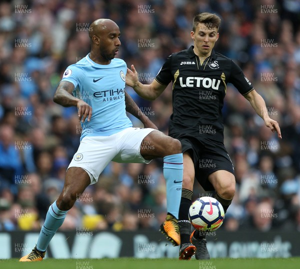 220418 - Manchester City v Swansea - Premier League - Fabian Delph of Manchester City is challenged by Tom Carroll of Swansea