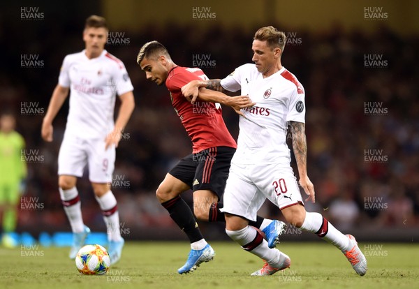 030819 - Manchester United v AC Milan - International Champions Cup - Andreas Pereira of Manchester United is tackled by Lucas Biglia of AC Milan