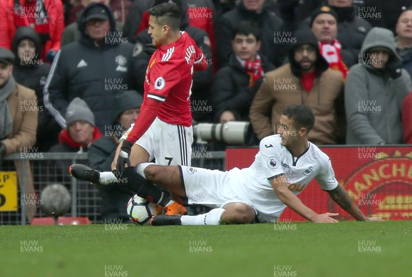 310318 - Manchester United v Swansea City - Premier League -  Kyle Naughton of Swansea brings down Alexis Sanchez of Manchester United