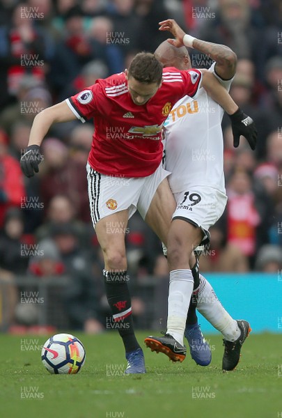 310318 - Manchester United v Swansea City - Premier League -  Andre Ayew of Swansea and and Nemanja Matic of Manchester United