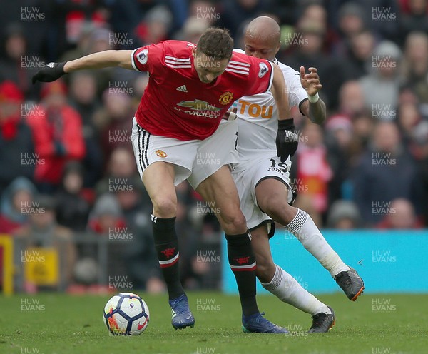 310318 - Manchester United v Swansea City - Premier League -  Andre Ayew of Swansea and and Nemanja Matic of Manchester United