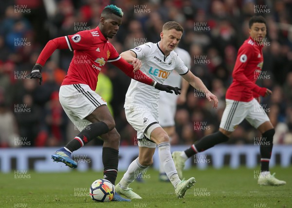 310318 - Manchester United v Swansea City - Premier League -  Kyle Naughton of Swansea and Paul Pogba of Manchester United