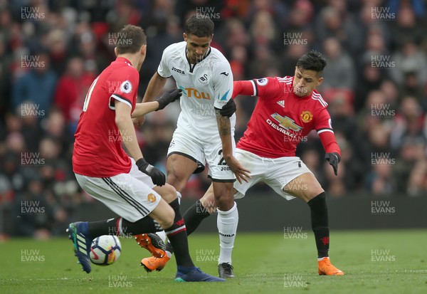 310318 - Manchester United v Swansea City - Premier League -  Kyle Naughton of Swansea is tackled by Nemanja Matic and Alexis Sanchez of Manchester United