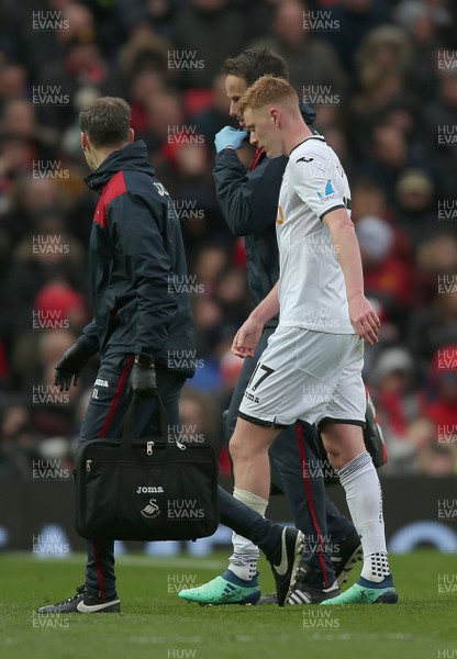 310318 - Manchester United v Swansea City - Premier League -  Sam Clucas of Swansea leaves the field injured in the second half 