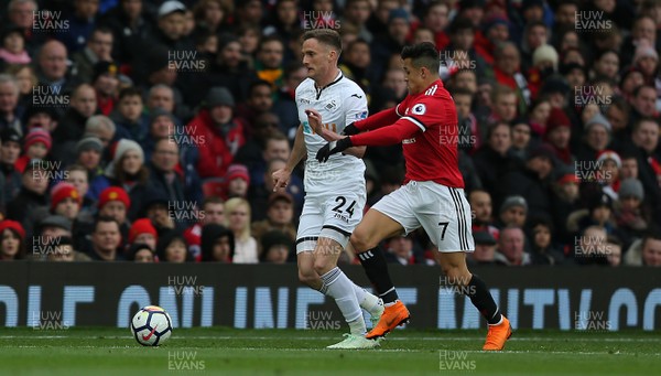 310318 - Manchester United v Swansea City - Premier League -  Alexis Sanchez of Manchester United and Andy King of Swansea