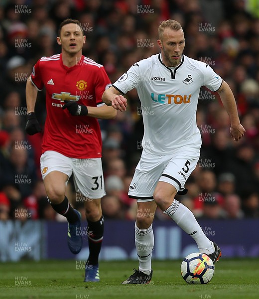 310318 - Manchester United v Swansea City - Premier League -  Mike Van Der Hoorn of Swansea and Nemanja Matic of Manchester United
