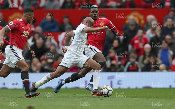 310318 - Manchester United v Swansea City - Premier League -  Paul Pogba of Manchester United and Andre Ayew of Swansea